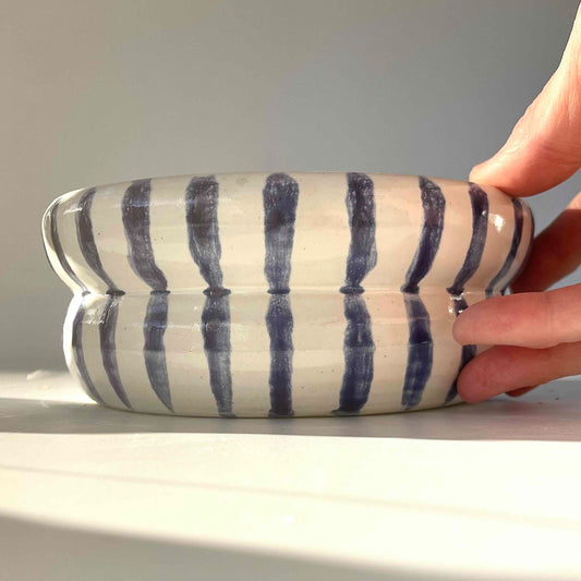 ribbed planter with drainiage hole, wheel-thrown by Hey Moon ceramics. Painted on the exterior with a glossy white glaze and handpainted navy blue stripes.