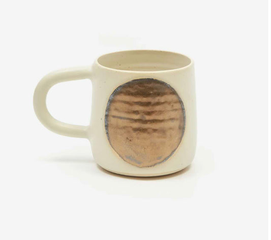 white mug with hand painted circular bronze moon. wheel-thrown by hey moon ceramics.
