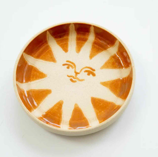 white stoneware catch all with handpainted orange sun with face by hey moon ceramics