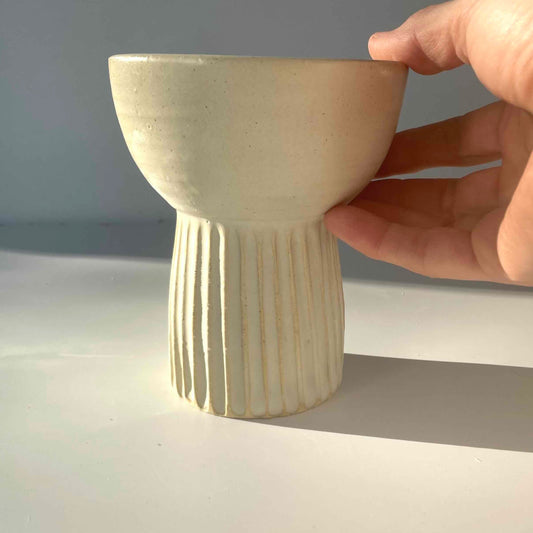 Matte white vase with ribbed detail at bottom and bowl top. Wheen thrown by Hey Moon Ceramics.
