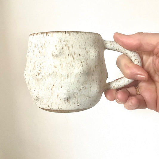 Bumpy Mug - Hey Moon Ceramics wheel-thrown mug with speckled clay and off-white glaze. Hand manipulated to create a bumpy exterior.