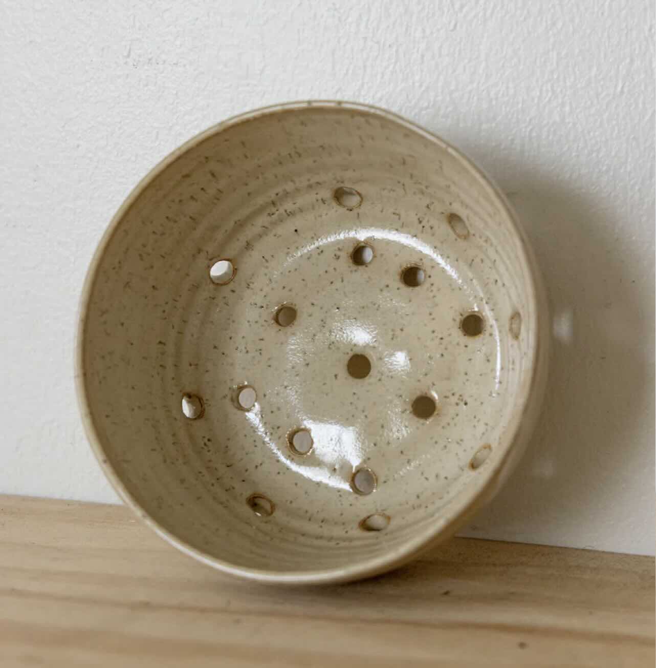 berry bowl made by Hey moon Ceramics. Side view whoing drainiage holes