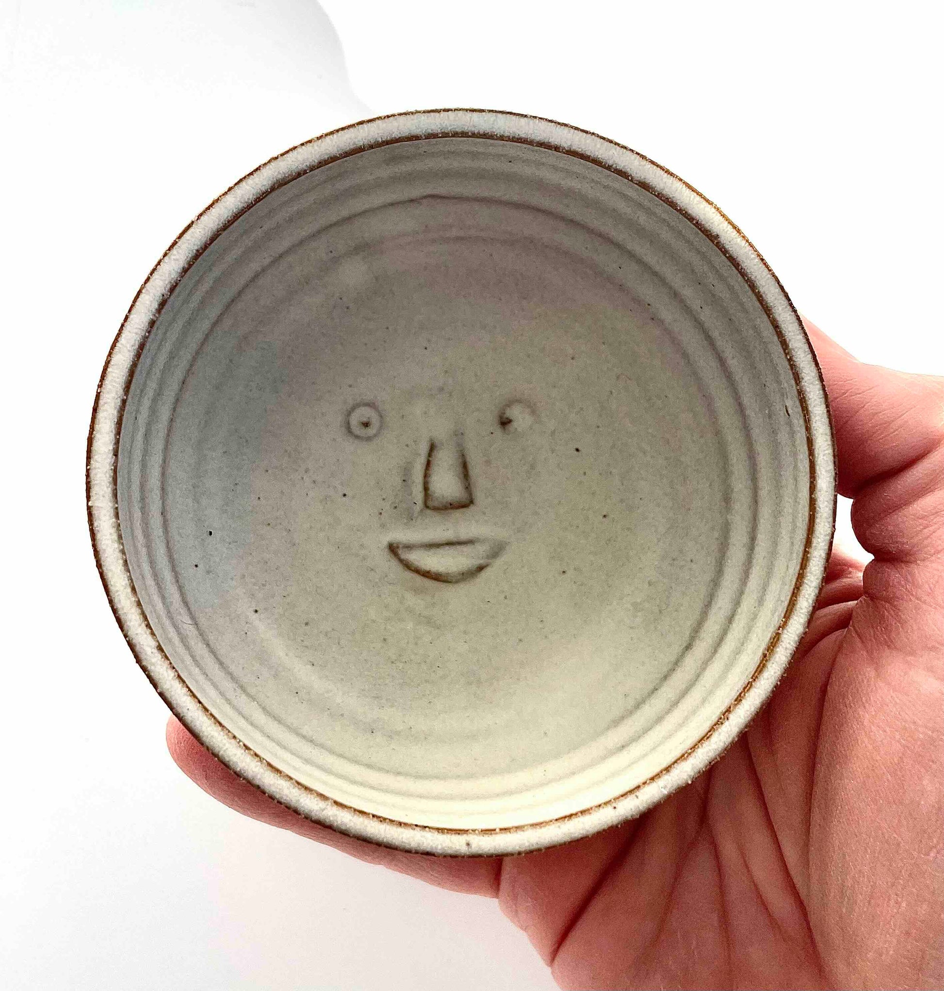 small white stoneware bowl with moon face at bottom - Hey Moon Ceramics
