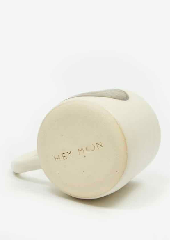 white mug with hand painted circular bronze moon. wheel-thrown by hey moon ceramics.